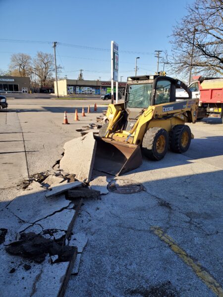 Bobcat removing broken blacktop