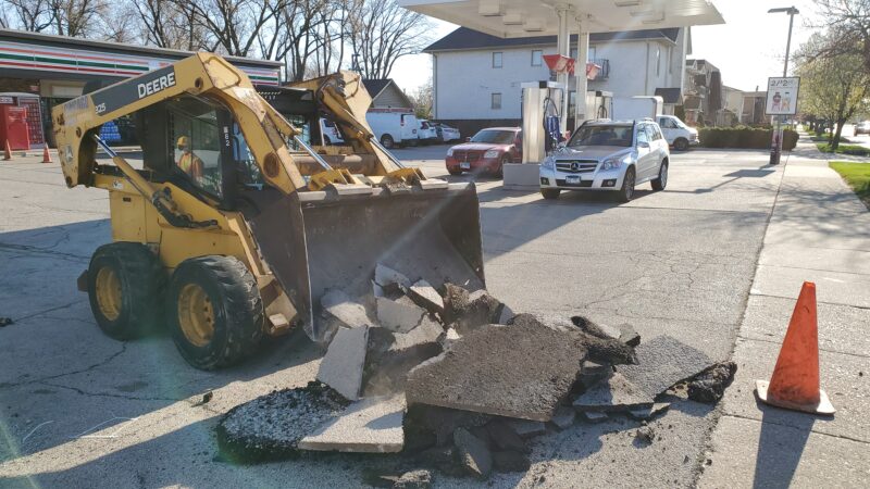 Bobcat piling up blacktop debris