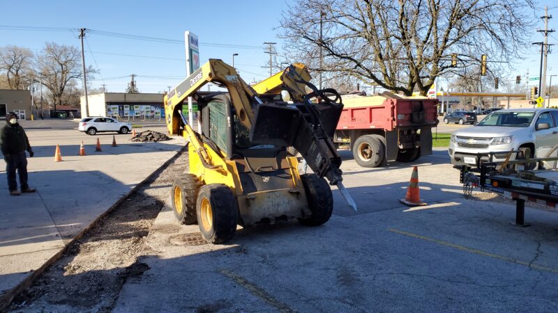 Bobcat with a Jackhammer attachment