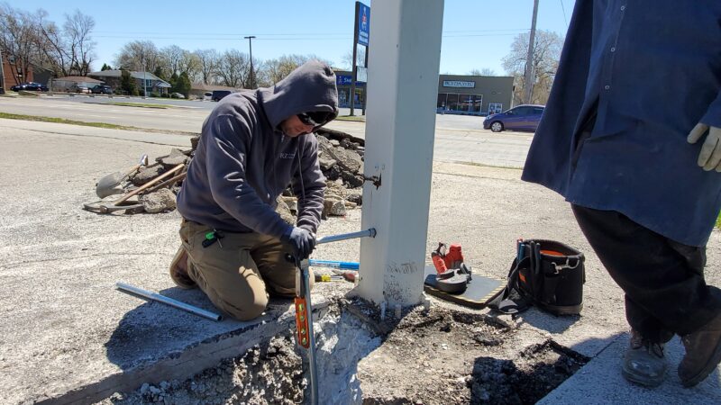 Electricians connecting pipes together.
