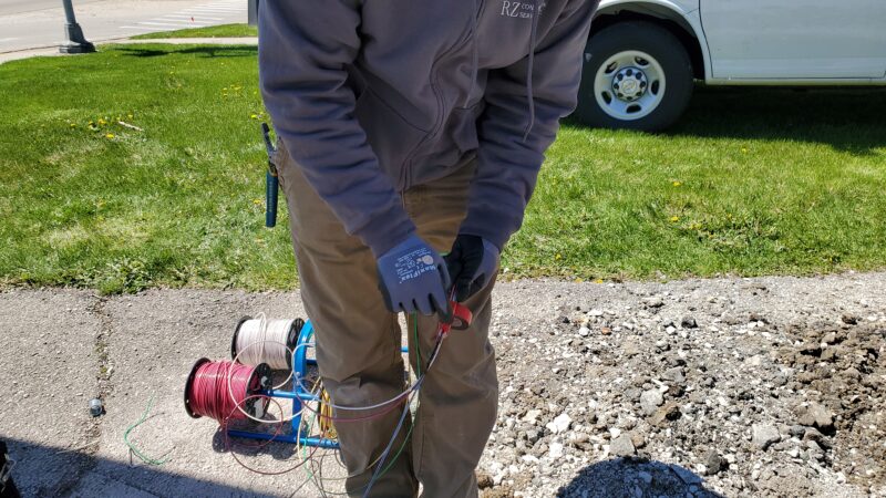 Electrician taping electrical wiring.