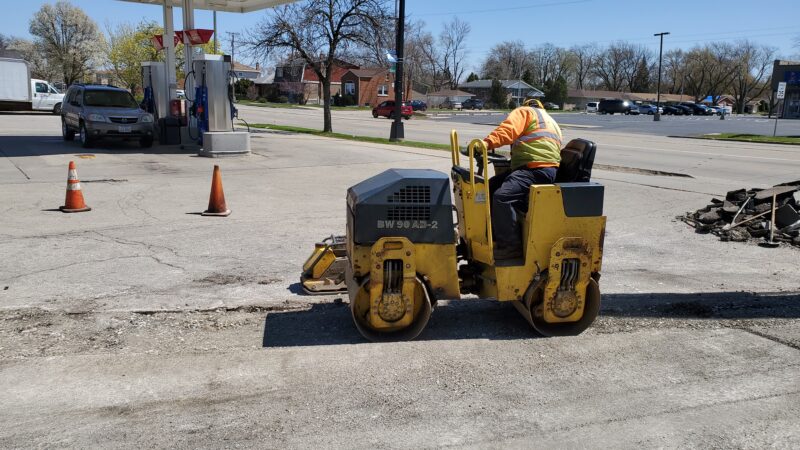 Steam roller flattening a trench