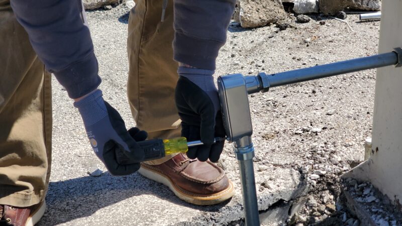 Electrician screwing on a faceplate.