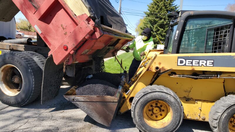 Bobcat being loaded with blacktop