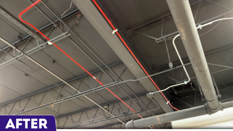 newly painted warehouse ceiling with pipes and wires